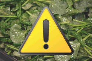 spinaci surgelati e simbolo di attenzione